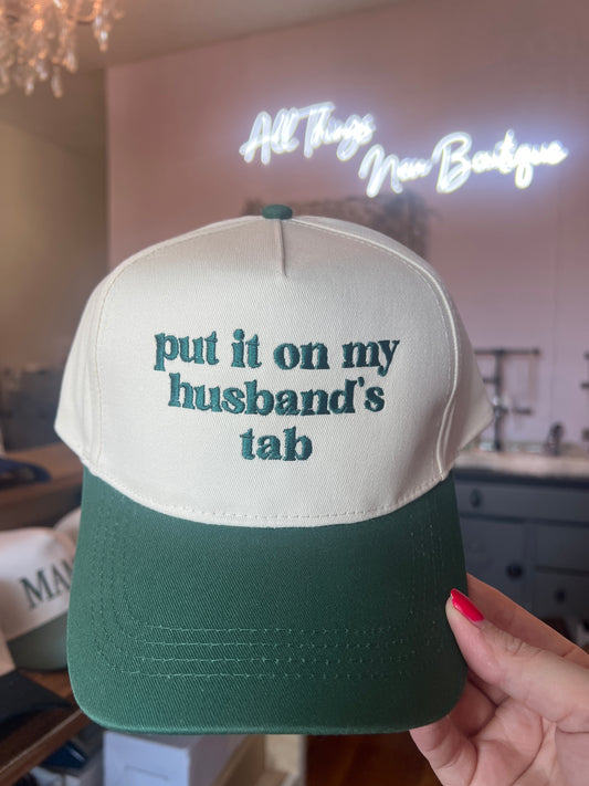 Trucker Hat — “put it on my husbands’s tab”